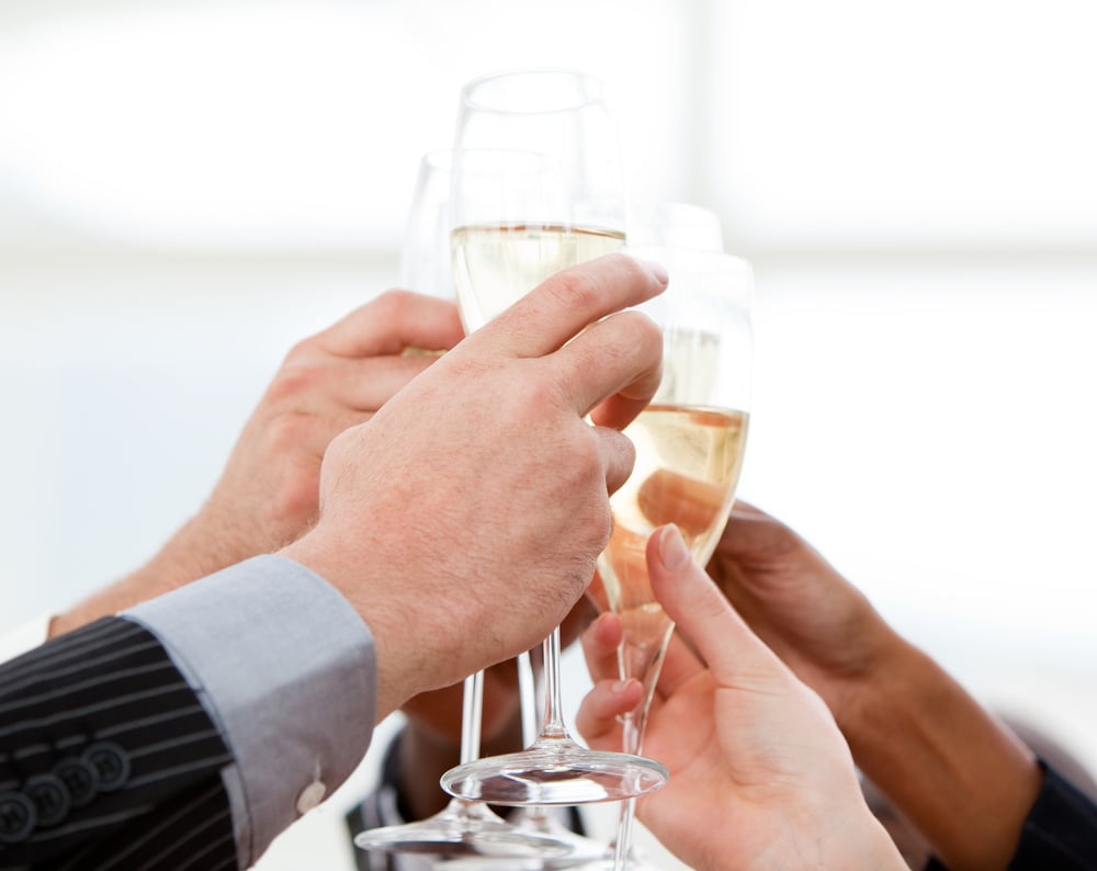 Close-up of businessmen celebrating an event with champagne in the company Close-up of businessmen celebrating an event with champagne in the company